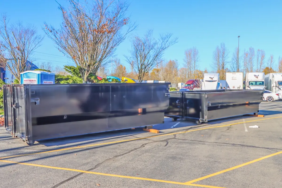 Professional dumpster rental service with roll-off container on residential driveway in Marshall